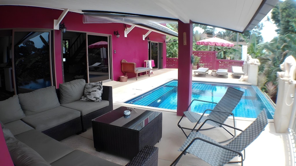Pink poolside with seating